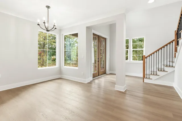 a kitchen with stainless steel appliances a sink a stove a refrigerator a center island and cabinets