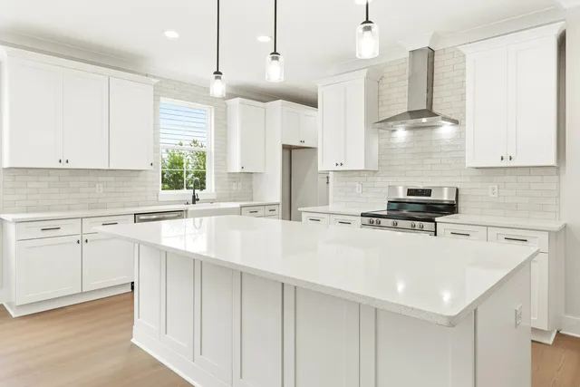 a large white kitchen with a large window