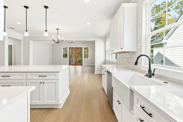 a view of a kitchen with white cabinets