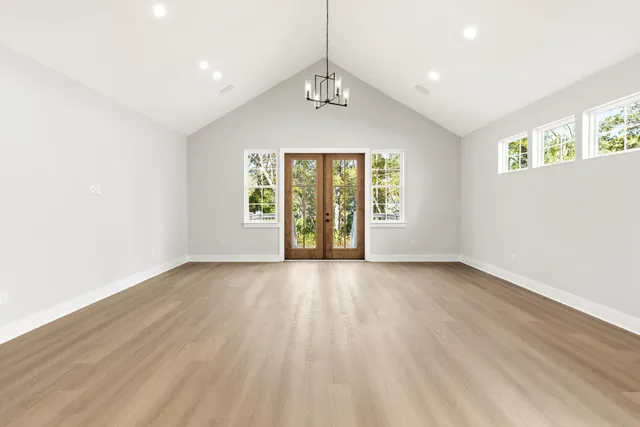 a view of a kitchen with wooden floor electronic appliances and window