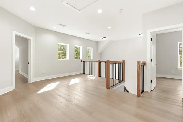 a view of a hallway with wooden floor