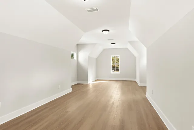 an empty room with a window and a ceiling fan