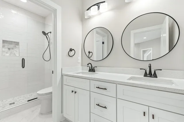 an empty room with wooden floor chandelier fan and windows