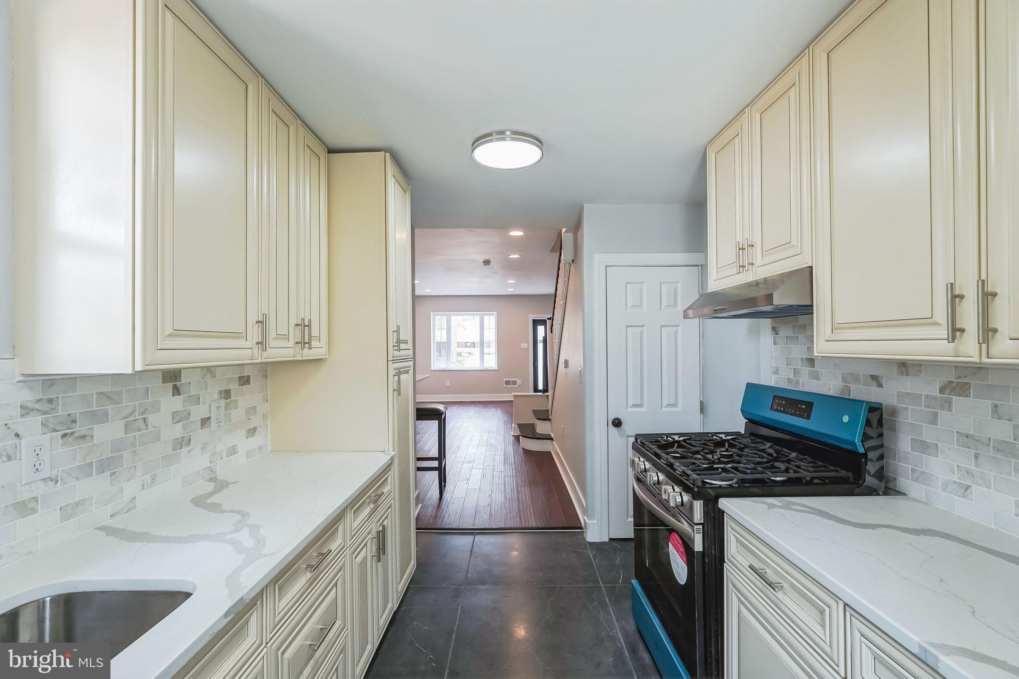 2020 East Cumberland Street Philadelphia, PA 19125 - Photo 12 of 36 a kitchen with granite countertop a sink stove and cabinets