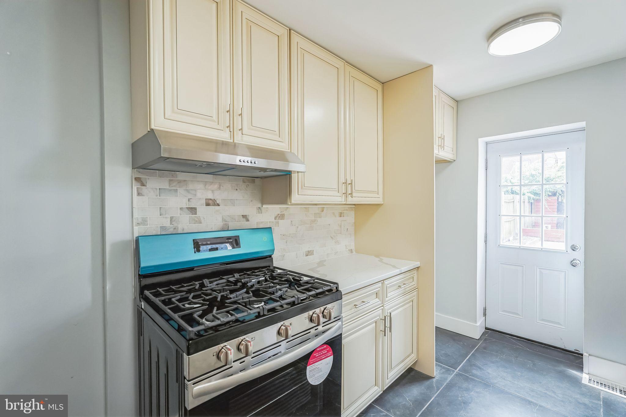 2020 East Cumberland Street Philadelphia, PA 19125 - Photo 13 of 36 a kitchen with stainless steel appliances a stove and white cabinets