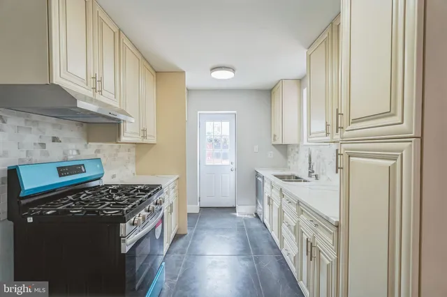 a kitchen with stainless steel appliances granite countertop a stove and a refrigerator
