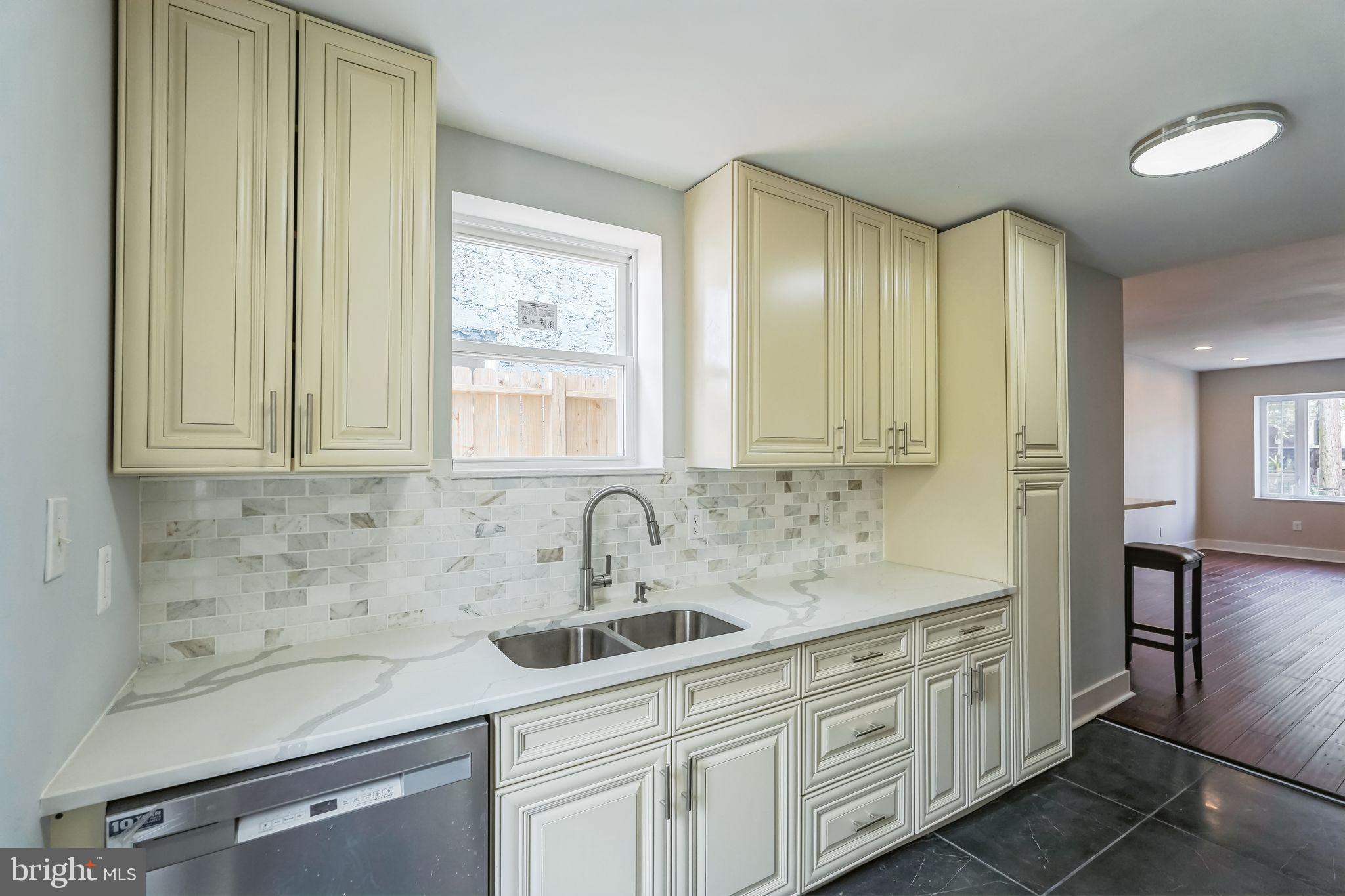 2020 East Cumberland Street Philadelphia, PA 19125 - Photo 15 of 36 a kitchen with white cabinets and sink