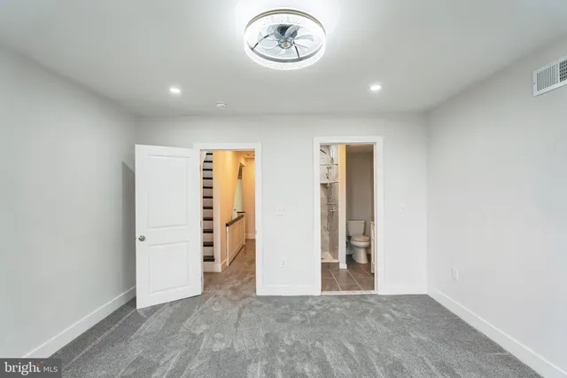 an empty room with a door and wooden floor