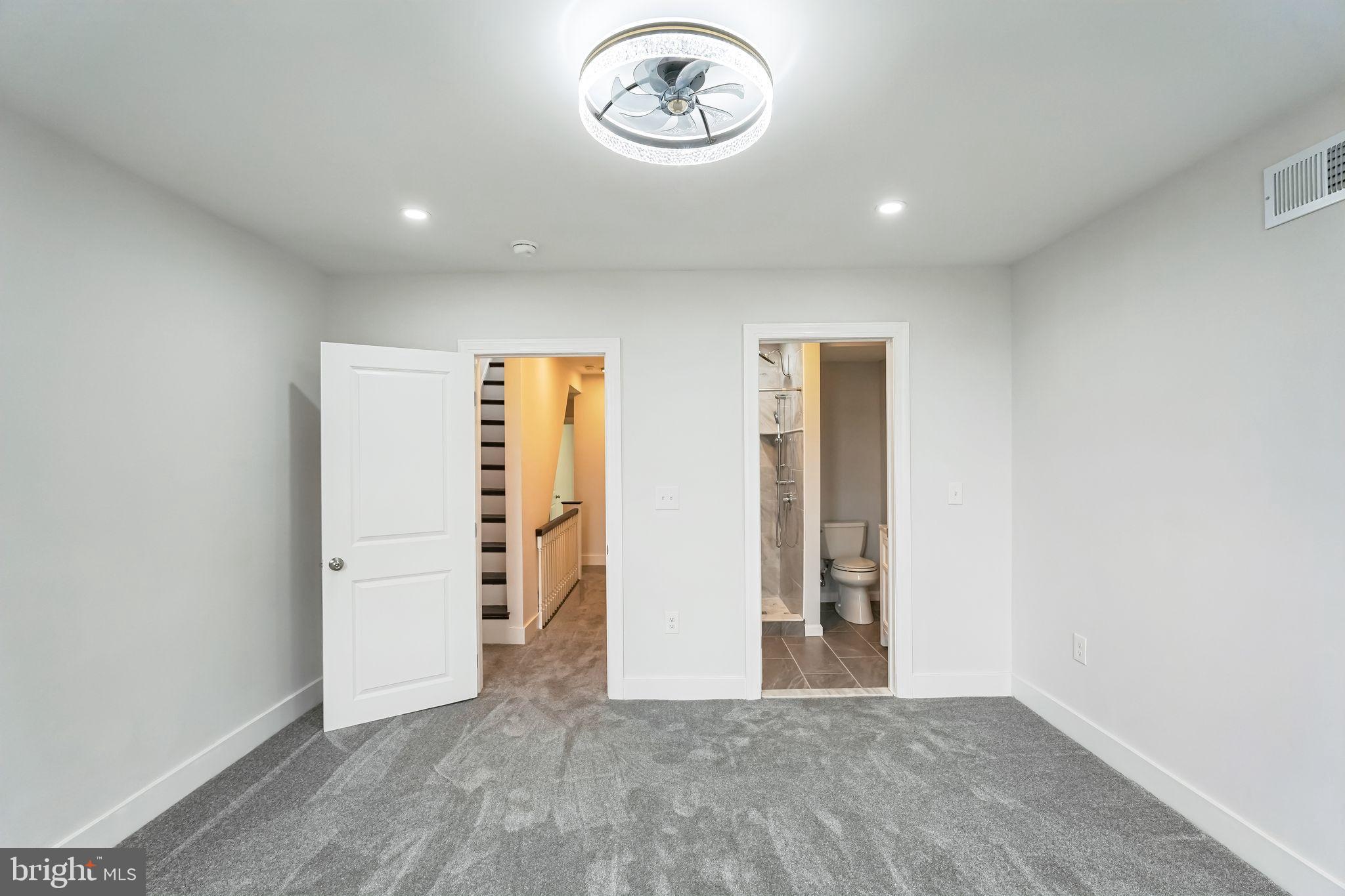 2020 East Cumberland Street Philadelphia, PA 19125 - Photo 16 of 36 an empty room with a door and wooden floor