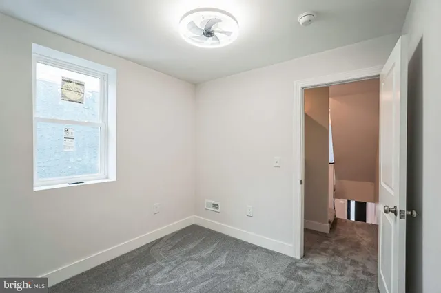 an empty room with windows and closet