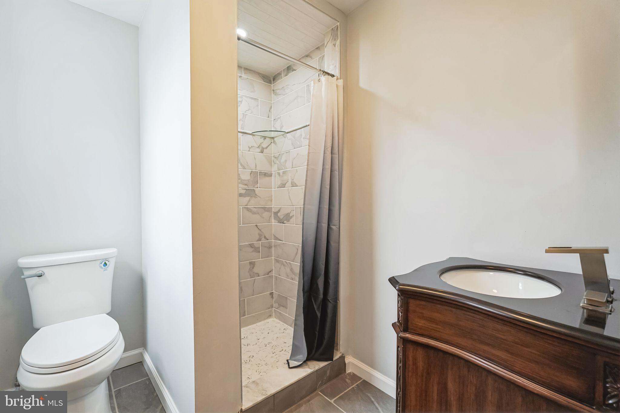 2020 East Cumberland Street Philadelphia, PA 19125 - Photo 25 of 36 a bathroom with a granite countertop toilet and a shower