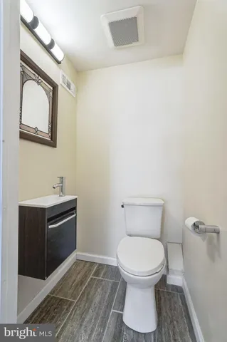 a bathroom with a toilet a sink and mirror