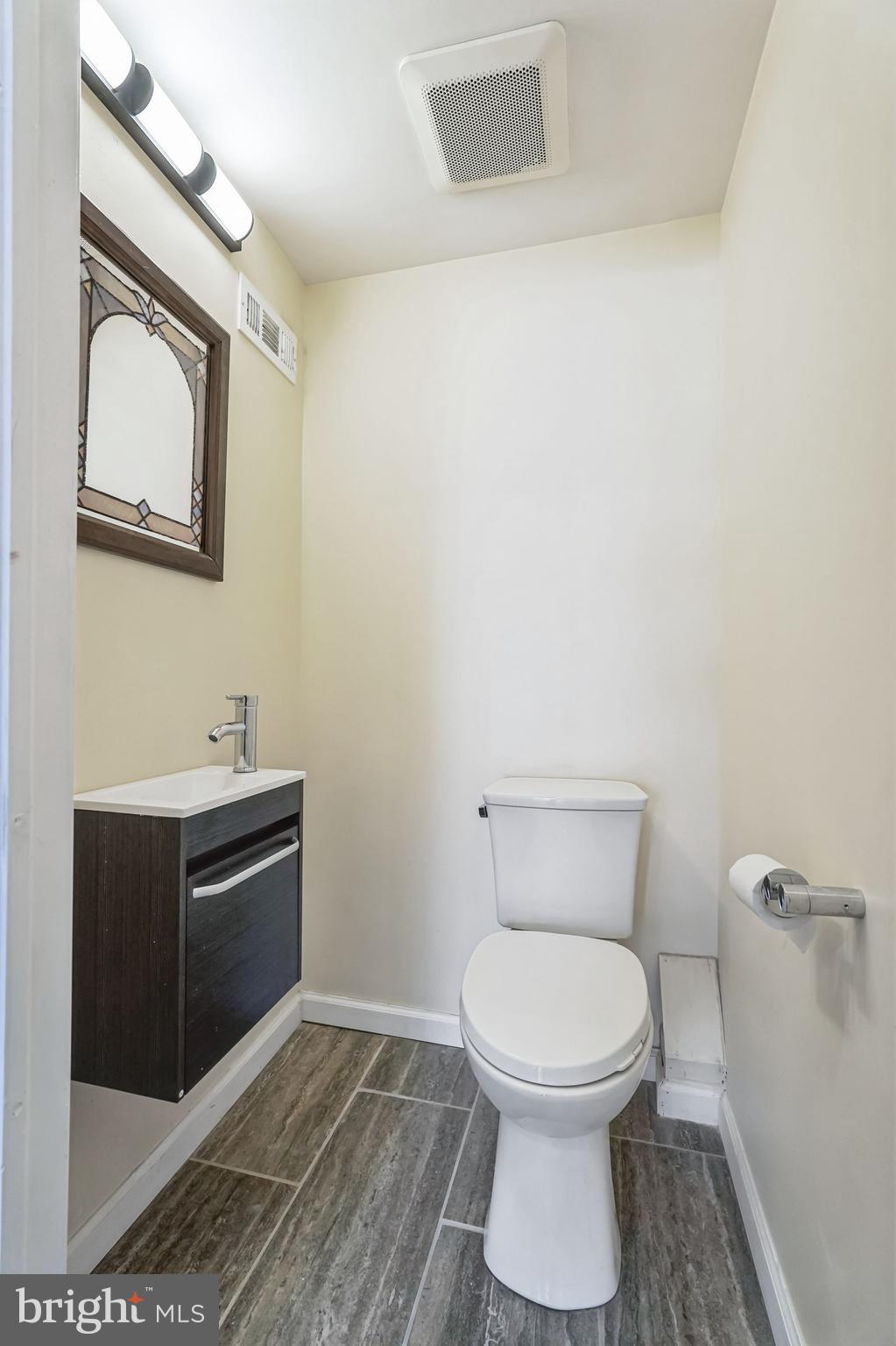 2020 East Cumberland Street Philadelphia, PA 19125 - Photo 31 of 36 a bathroom with a toilet a sink and mirror