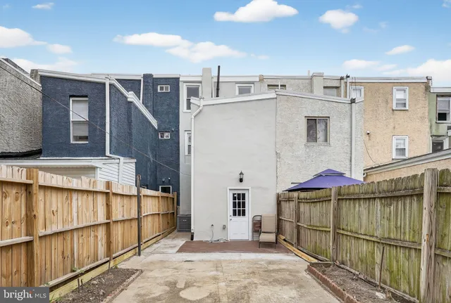 a view of a street with wooden fence