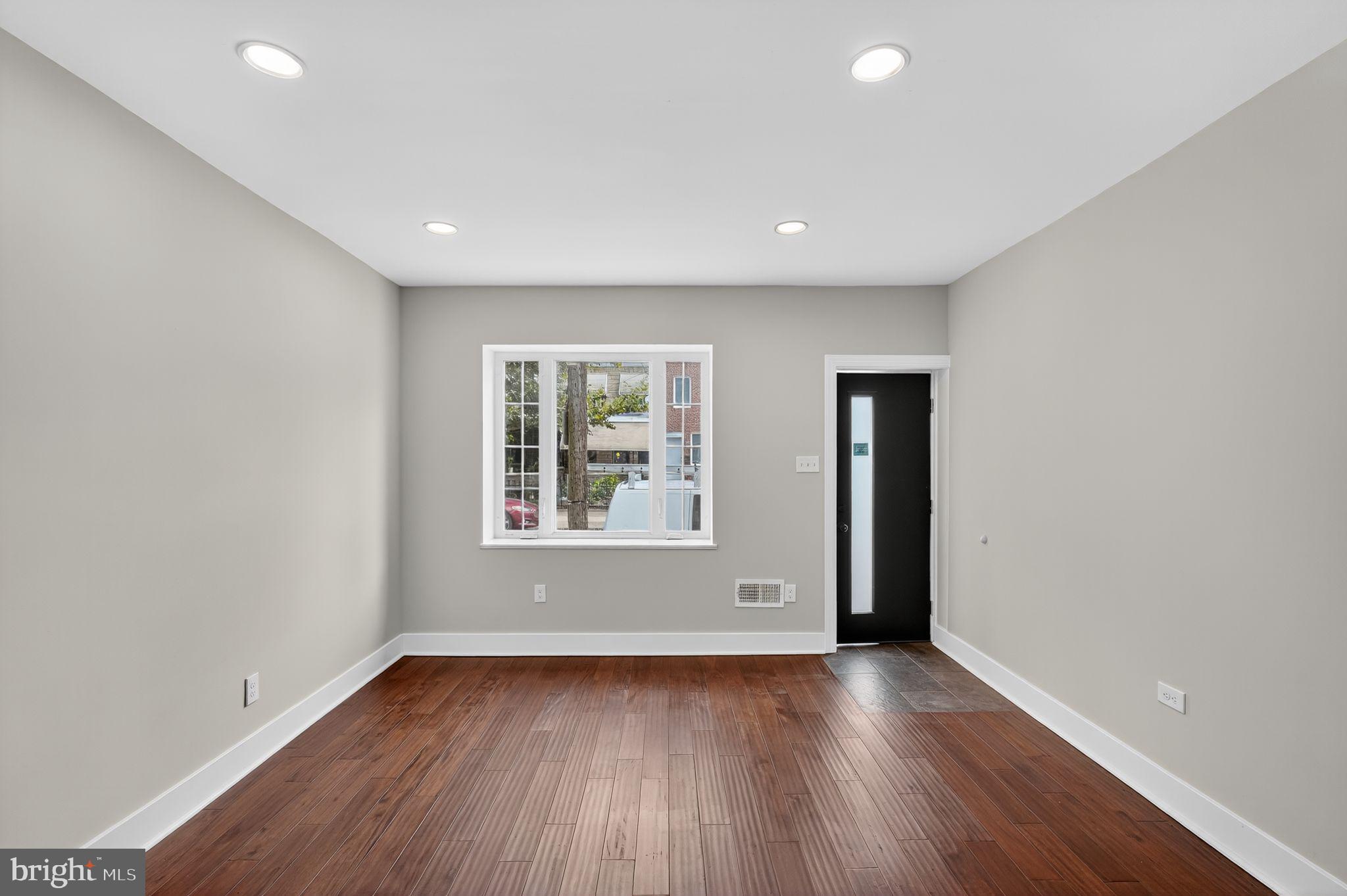 2020 East Cumberland Street Philadelphia, PA 19125 - Photo 5 of 36 an empty room with wooden floor and windows
