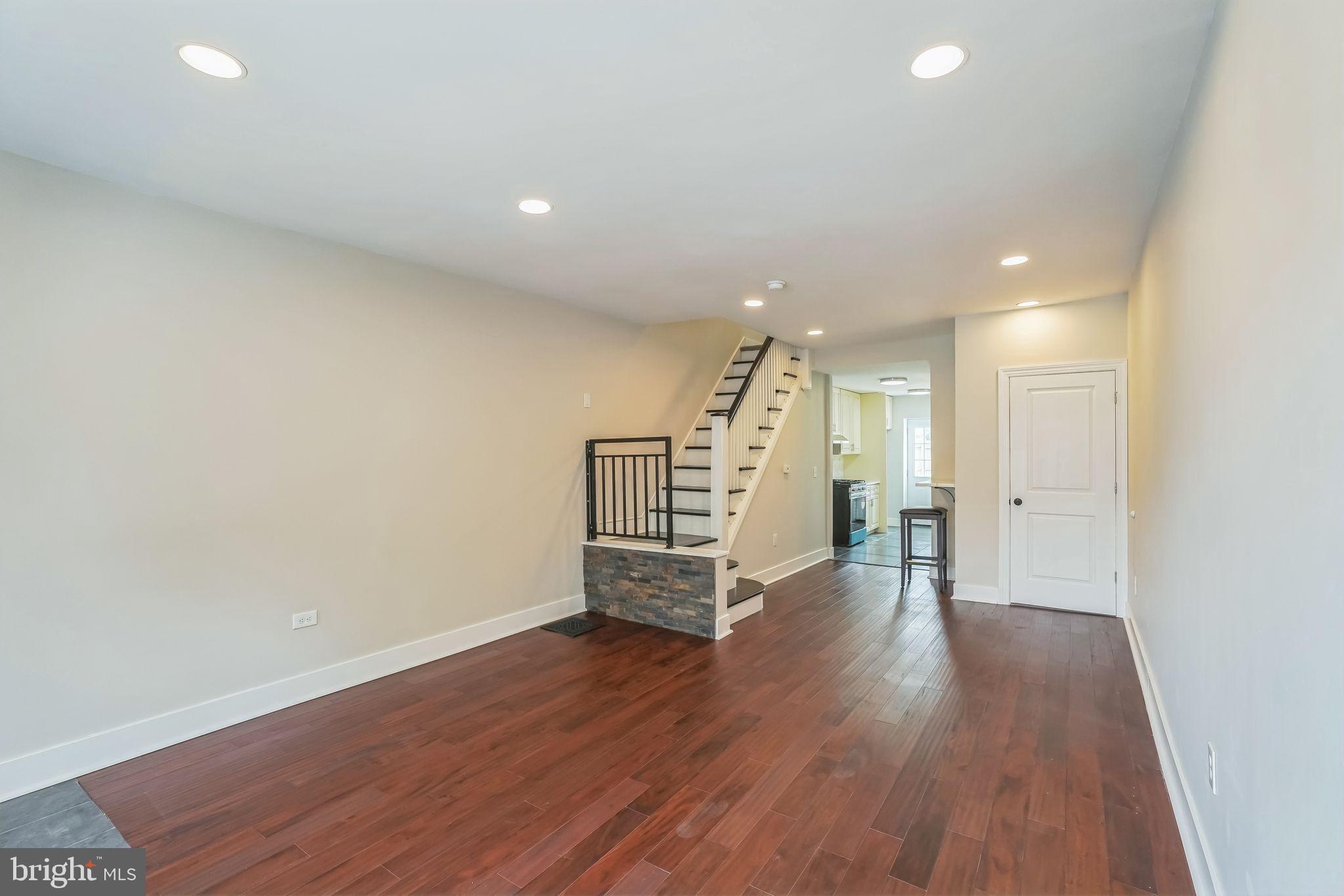 2020 East Cumberland Street Philadelphia, PA 19125 - Photo 8 of 36 an empty room with wooden floor and stairs