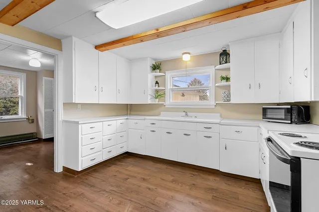 a kitchen with a sink a stove and cabinets
