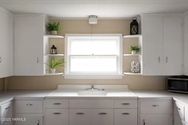 a kitchen with wooden floors and white appliances