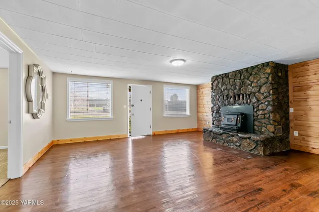 a living room with fireplace furniture and a fireplace