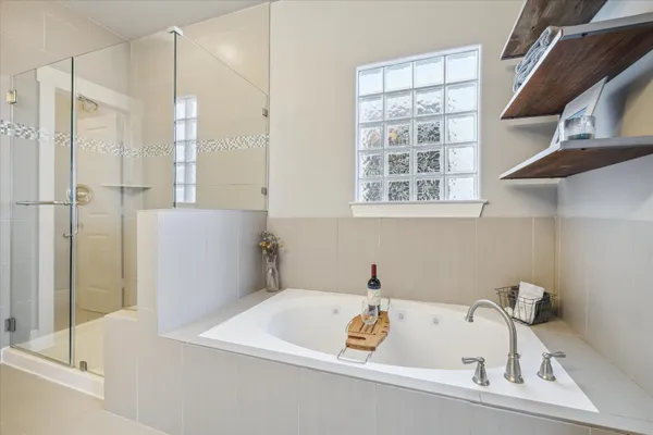 a bathroom with a tub and a shower