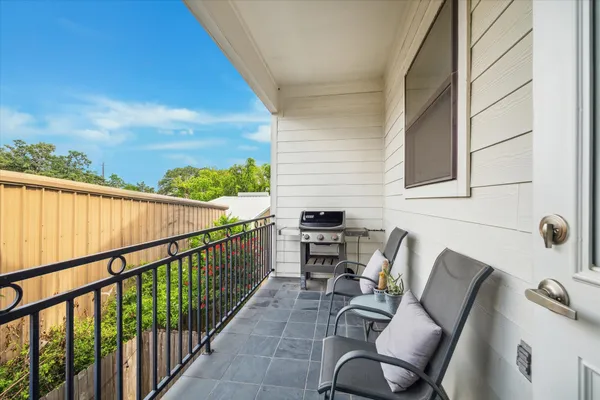 a view of a balcony with furniture