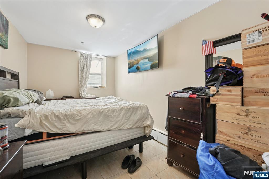 717 16th Street Union City, NJ 07087 - Photo 12 of 27 a bedroom with a bed and a closet