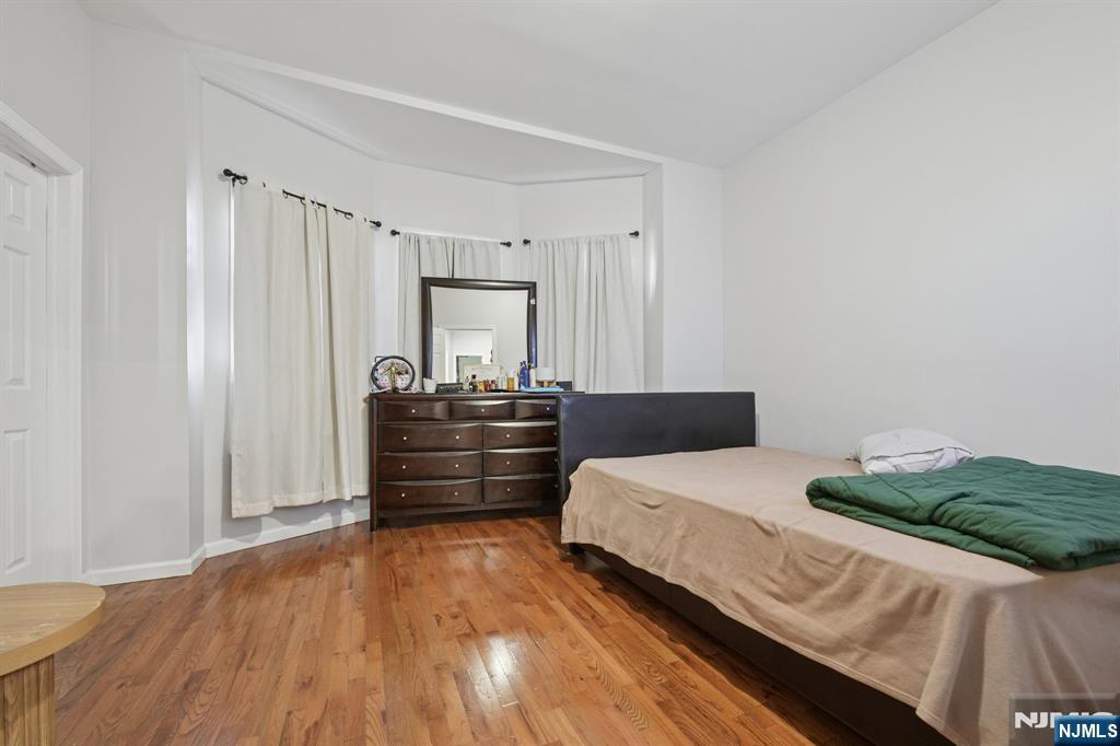 717 16th Street Union City, NJ 07087 - Photo 18 of 27 a bedroom with a bed and a dresser
