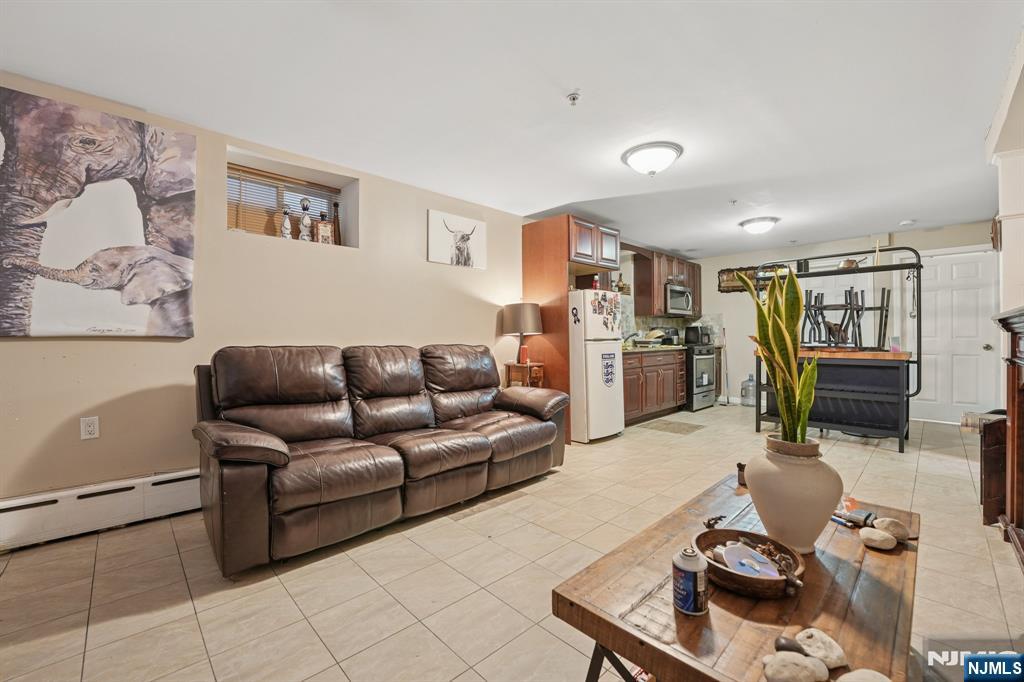 717 16th Street Union City, NJ 07087 - Photo 20 of 27 a living room with furniture and a flat screen tv