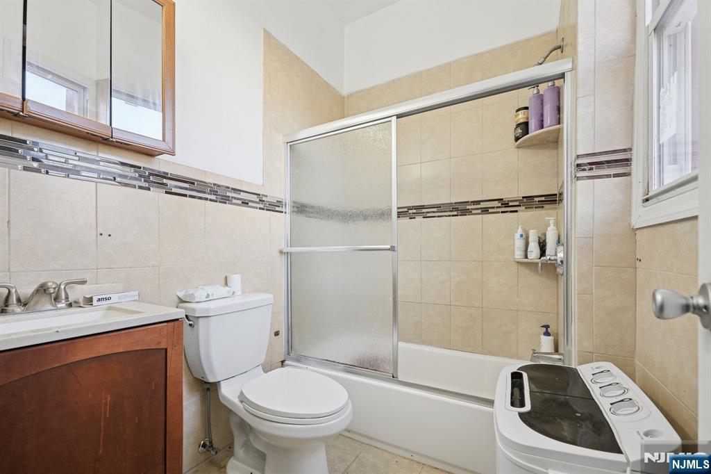 717 16th Street Union City, NJ 07087 - Photo 26 of 27 a bathroom with a sink a toilet and shower