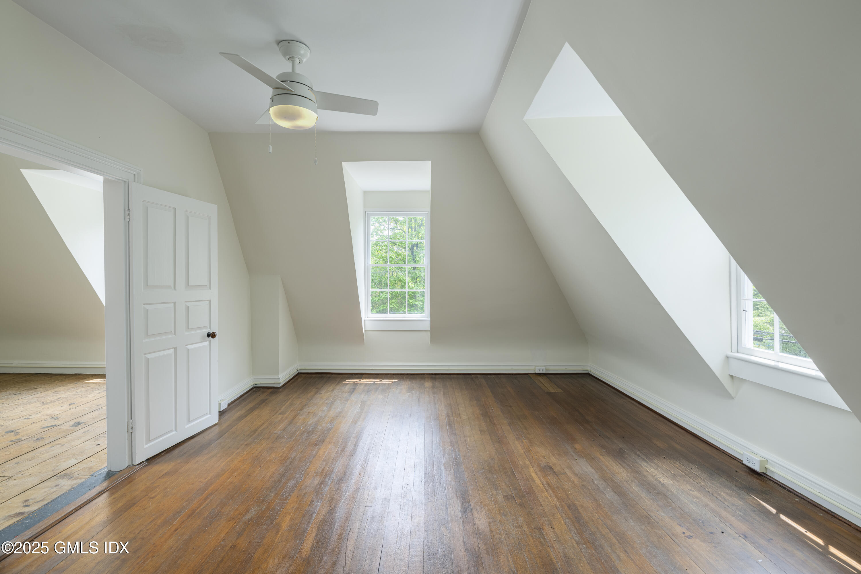 295 Taconic Road Greenwich, CT 06831 - Photo 15 of 35 wooden floor in an empty room with a window