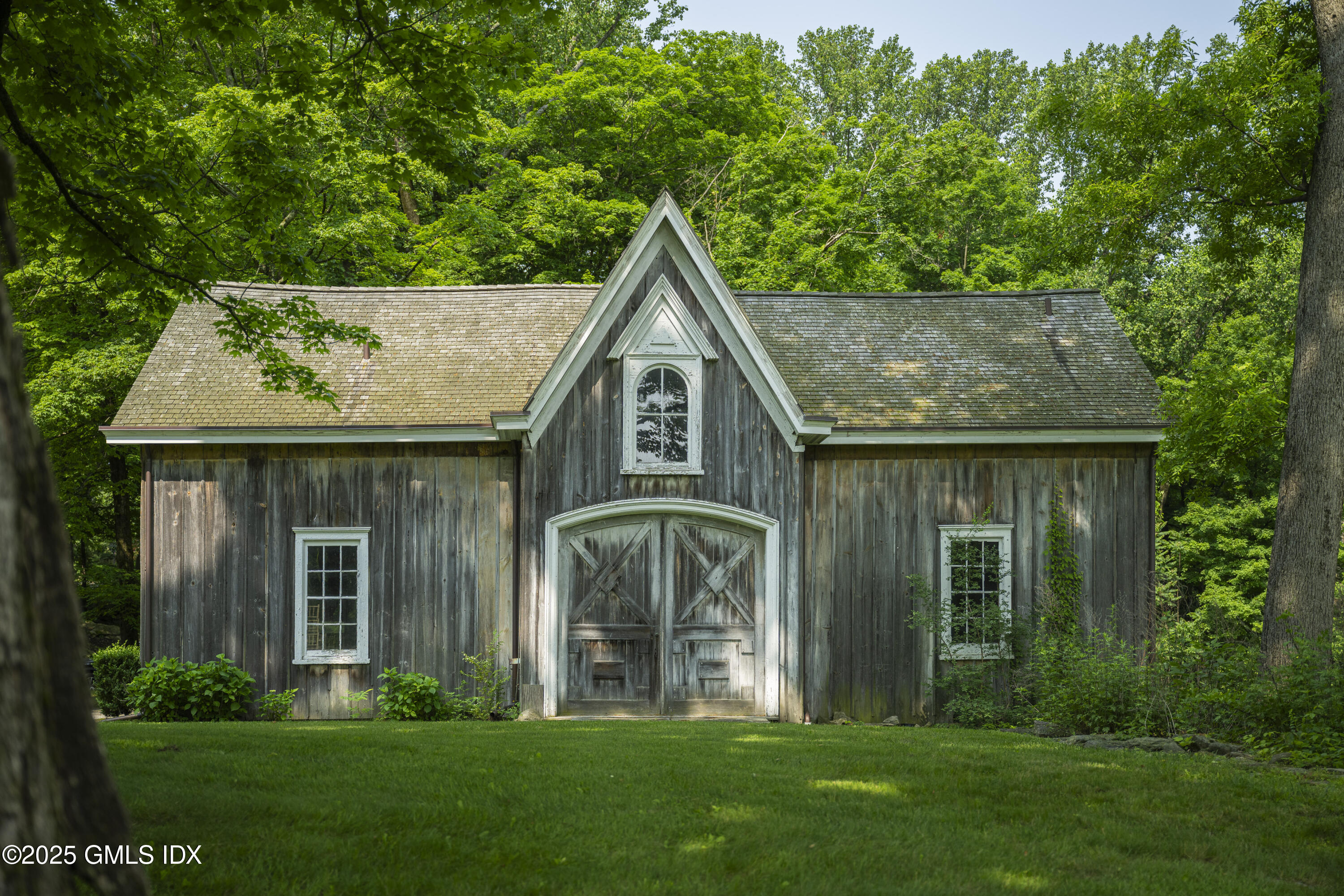 295 Taconic Road Greenwich, CT 06831 - Photo 20 of 35 a front view of a house with garden