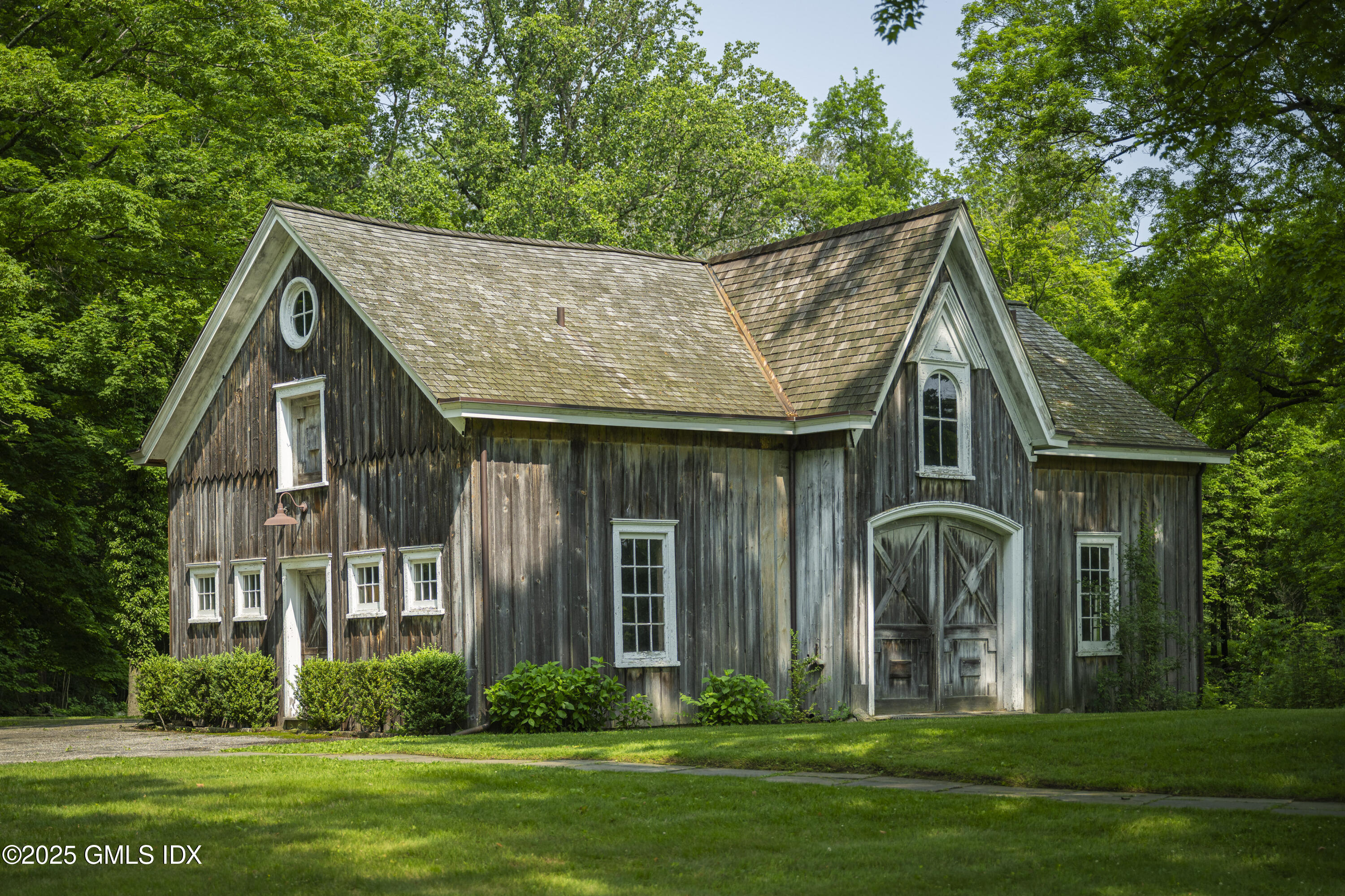 295 Taconic Road Greenwich, CT 06831 - Photo 2 of 35 a front view of a house with a garden