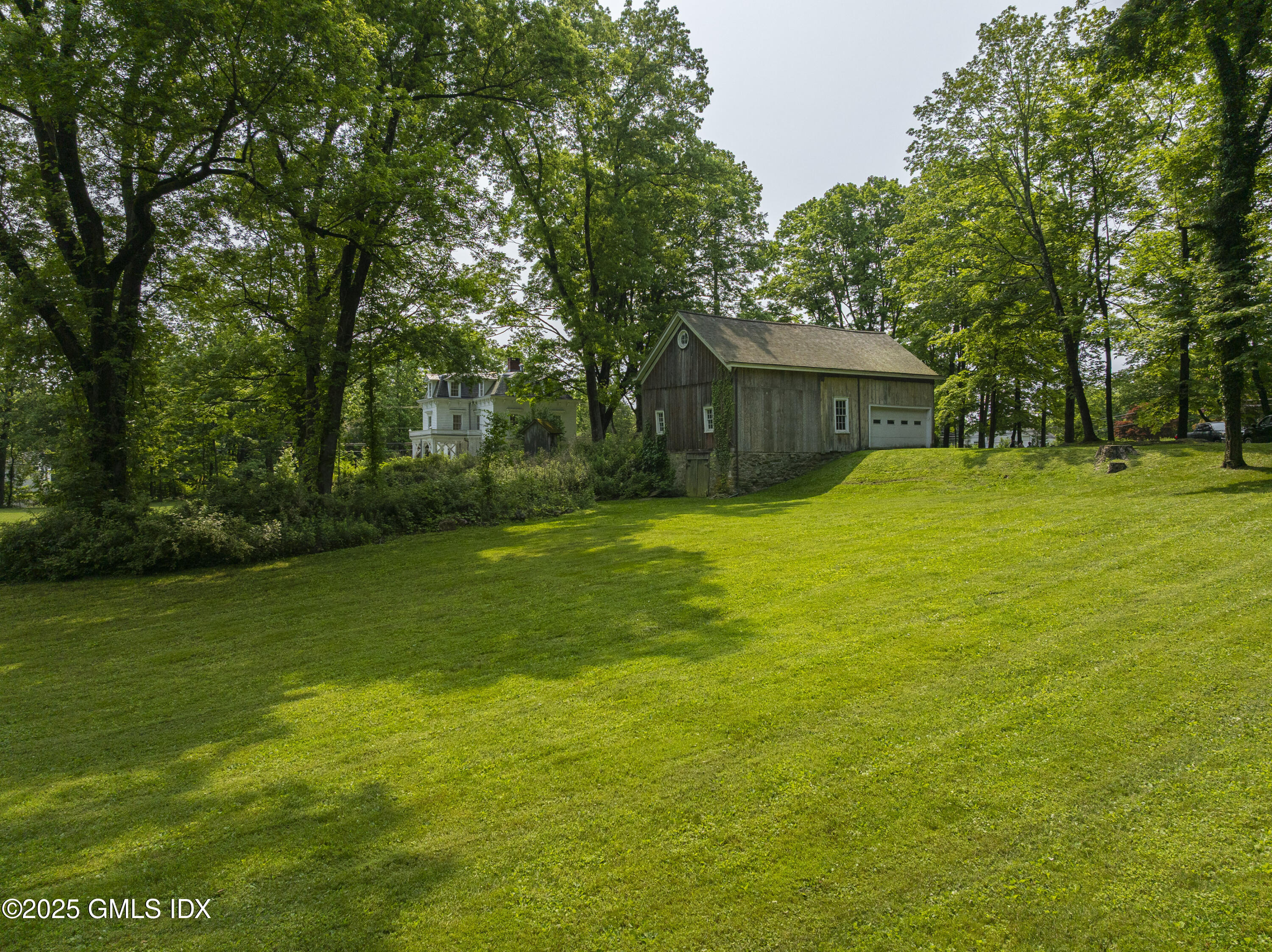 295 Taconic Road Greenwich, CT 06831 - Photo 22 of 35 a yellow house with a yard