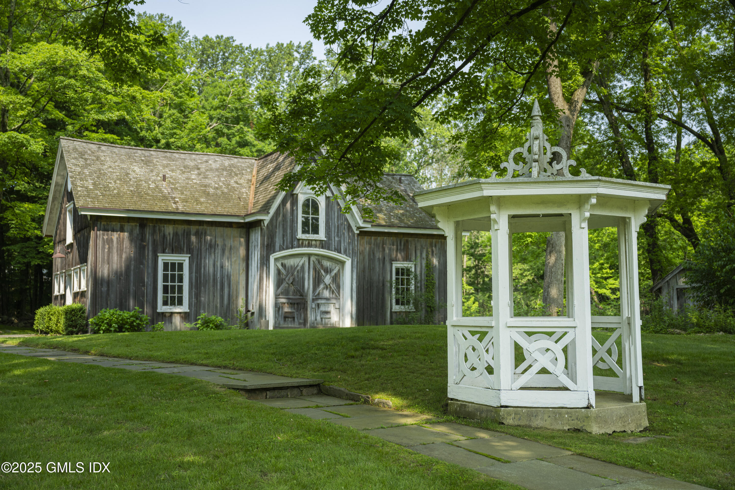 295 Taconic Road Greenwich, CT 06831 - Photo 28 of 35 a view of a white house with a big yard and large trees