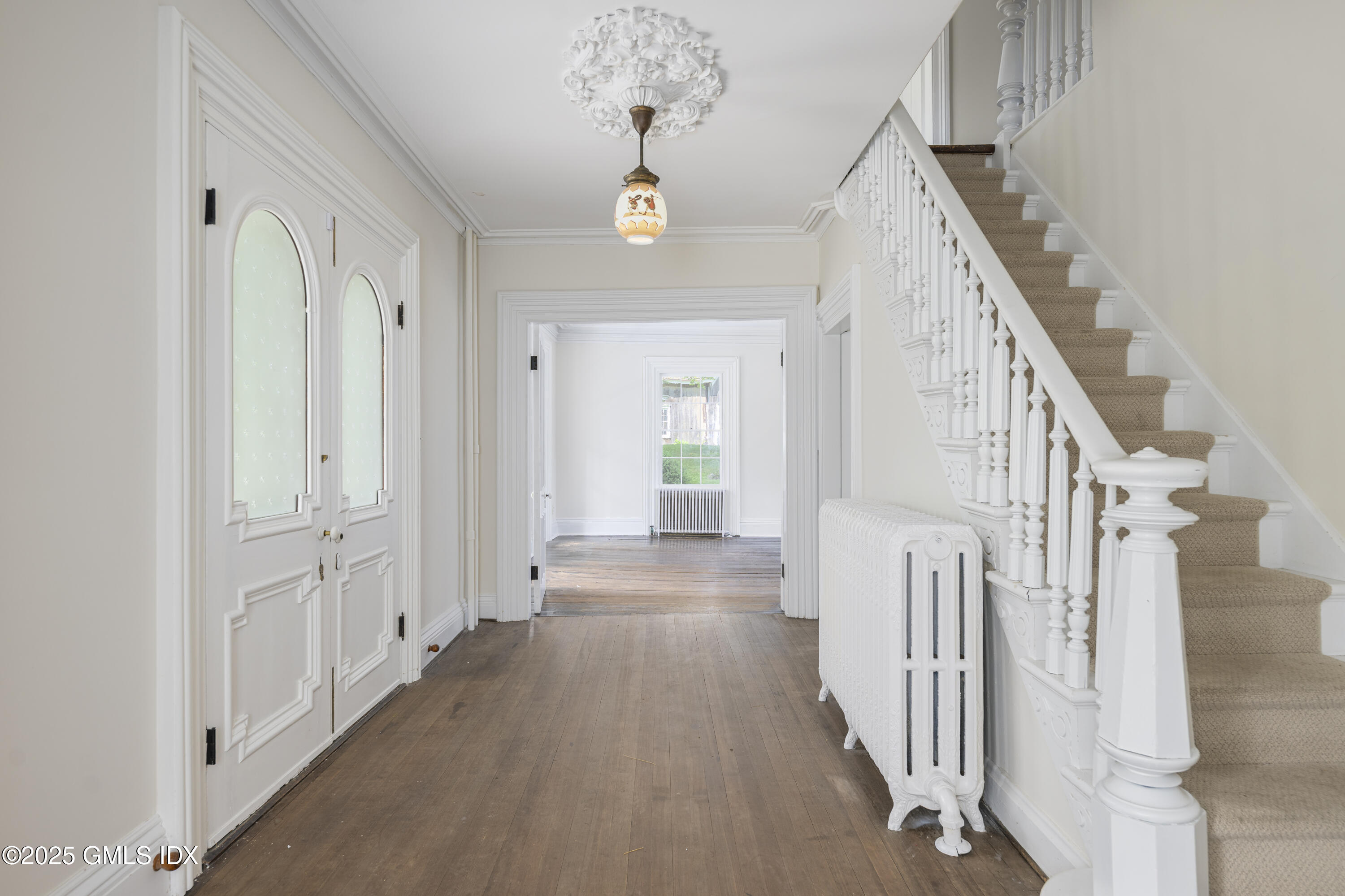 295 Taconic Road Greenwich, CT 06831 - Photo 3 of 35 a view of a hallway with wooden floor and staircase
