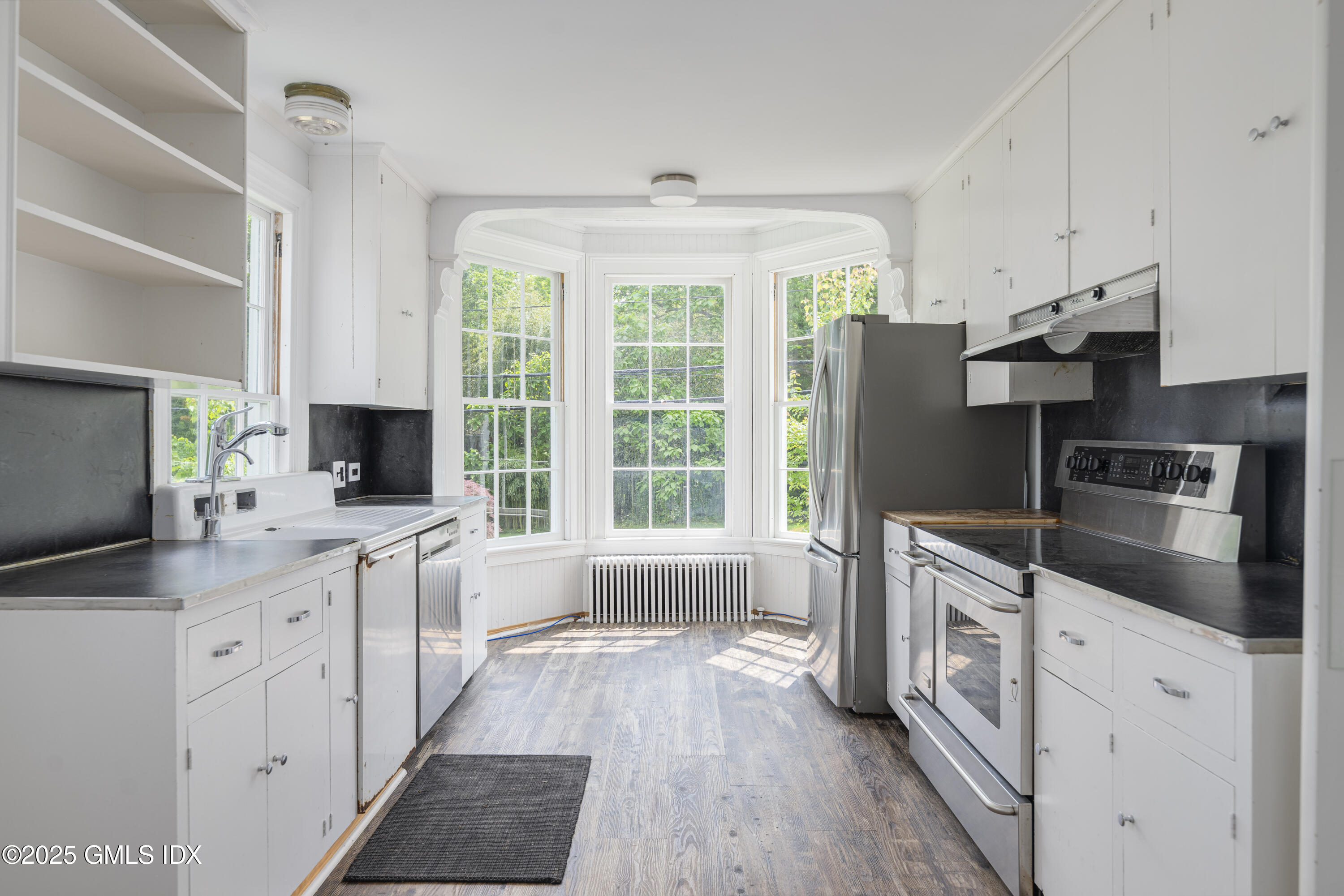 295 Taconic Road Greenwich, CT 06831 - Photo 4 of 35 a kitchen with stainless steel appliances a stove sink and refrigerator