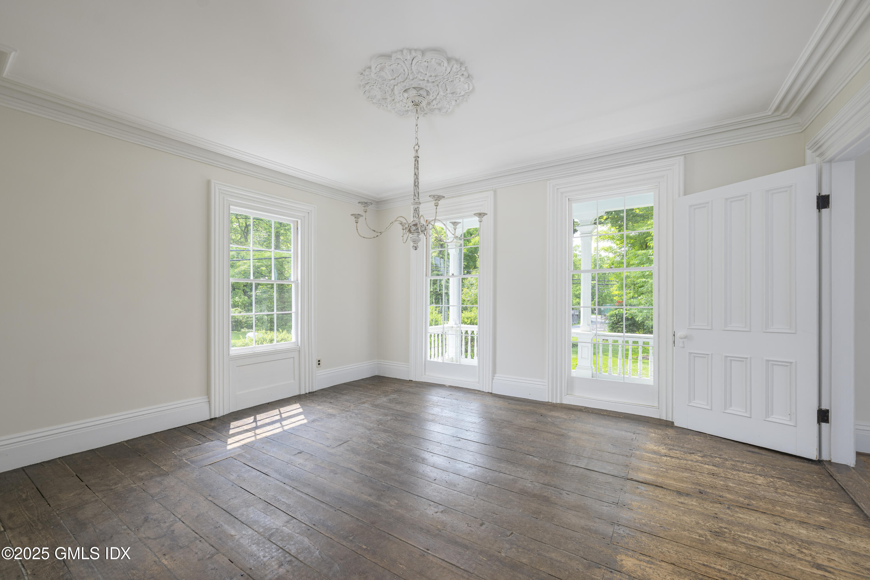295 Taconic Road Greenwich, CT 06831 - Photo 5 of 35 a view of an empty room with wooden floor and a window