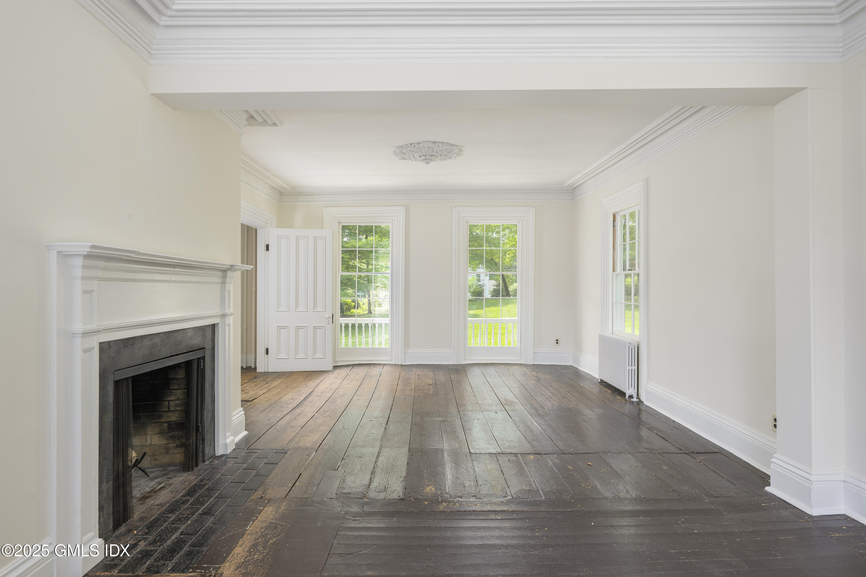 295 Taconic Road Greenwich, CT 06831 - Photo 6 of 35 a view of empty room with wooden floor and fireplace