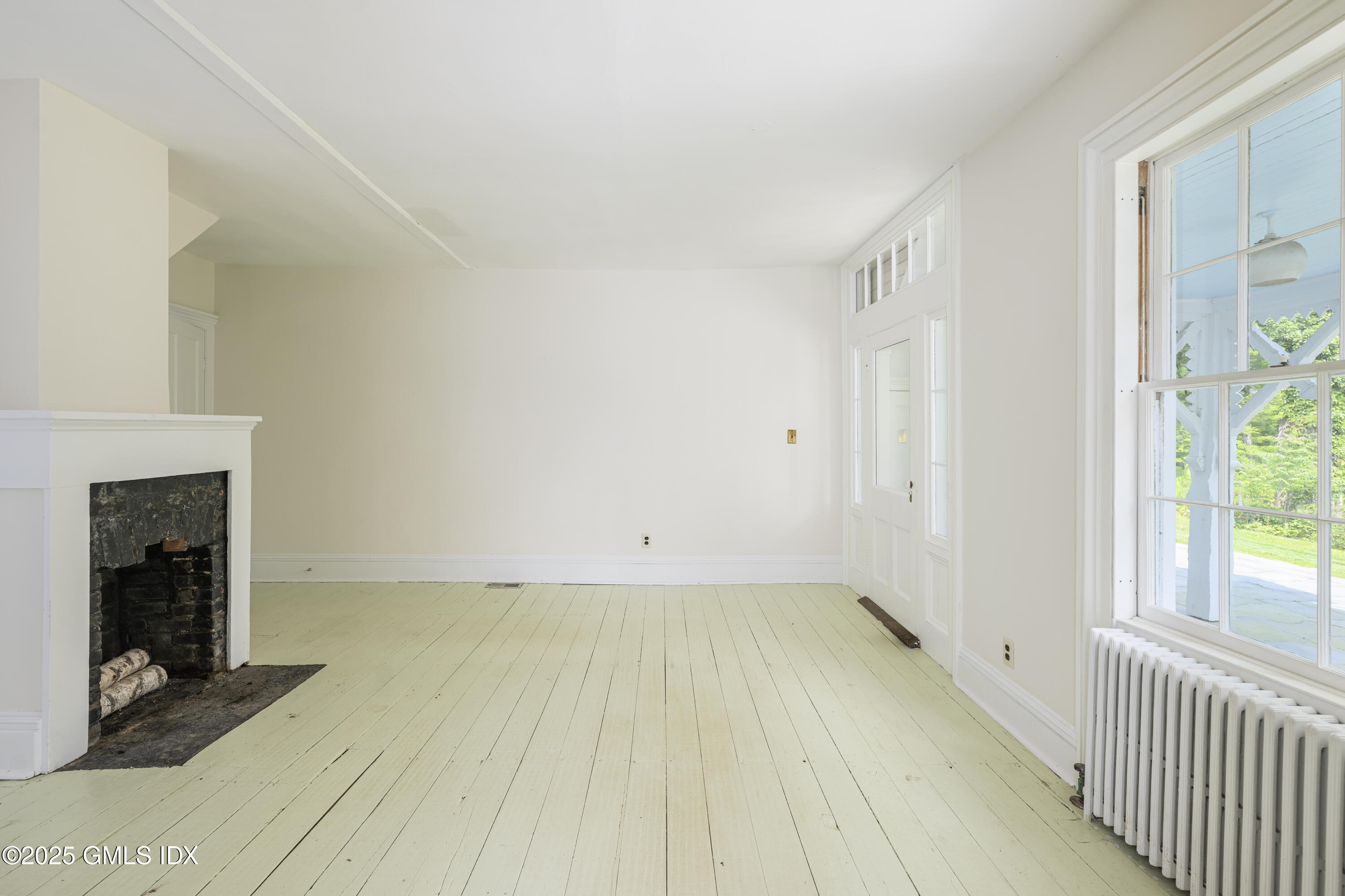 295 Taconic Road Greenwich, CT 06831 - Photo 7 of 35 a view of a room with wooden floor and a fireplace