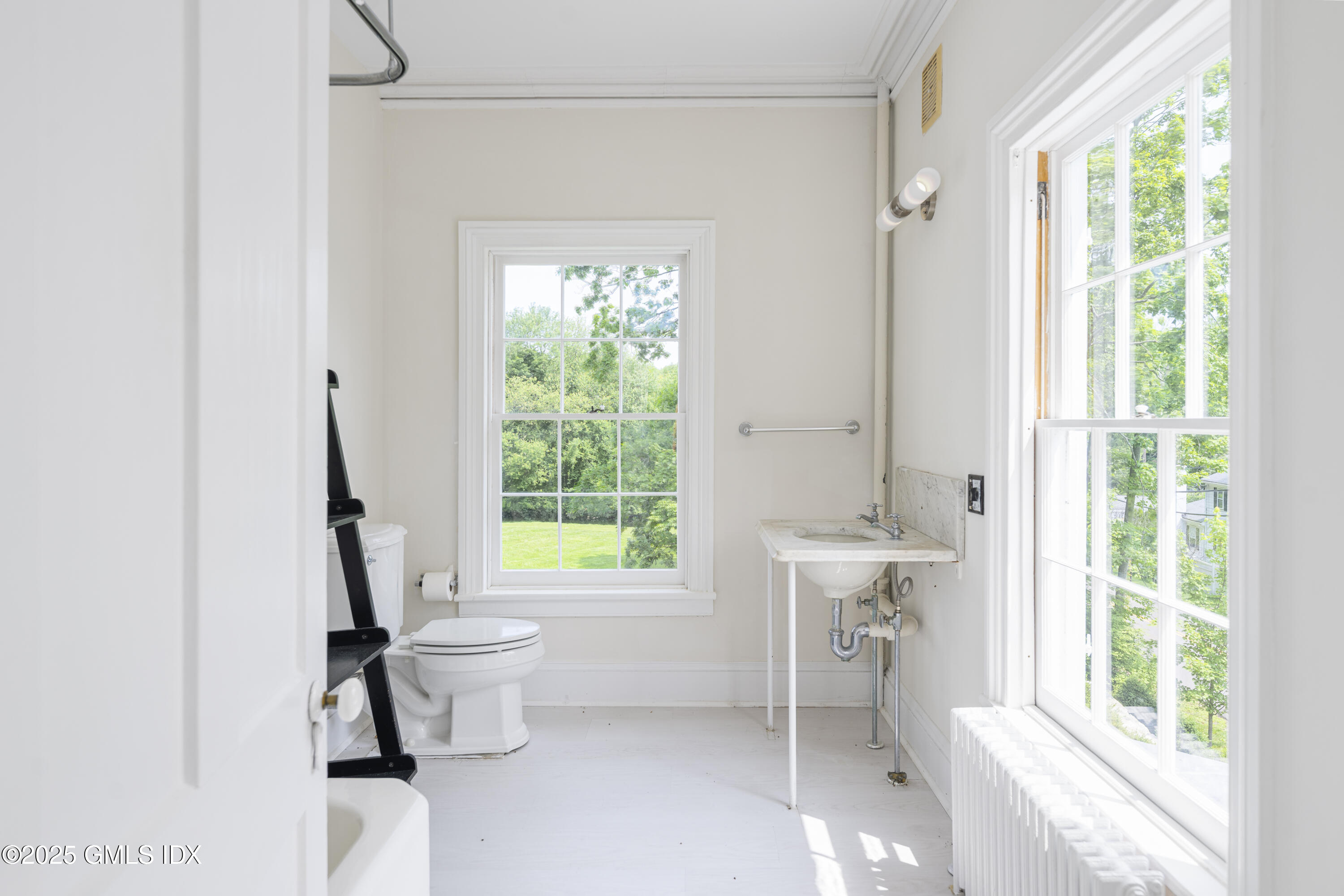 295 Taconic Road Greenwich, CT 06831 - Photo 9 of 35 a bathroom with a toilet sink and window