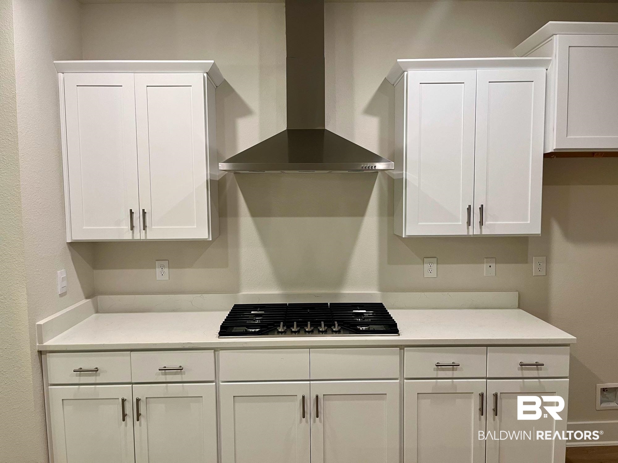 330 Barndling Street Fairhope, AL 36532 - Photo 12 of 31 Kitchen featuring black gas stovetop, white cabinetry, and wall chimney range hood
