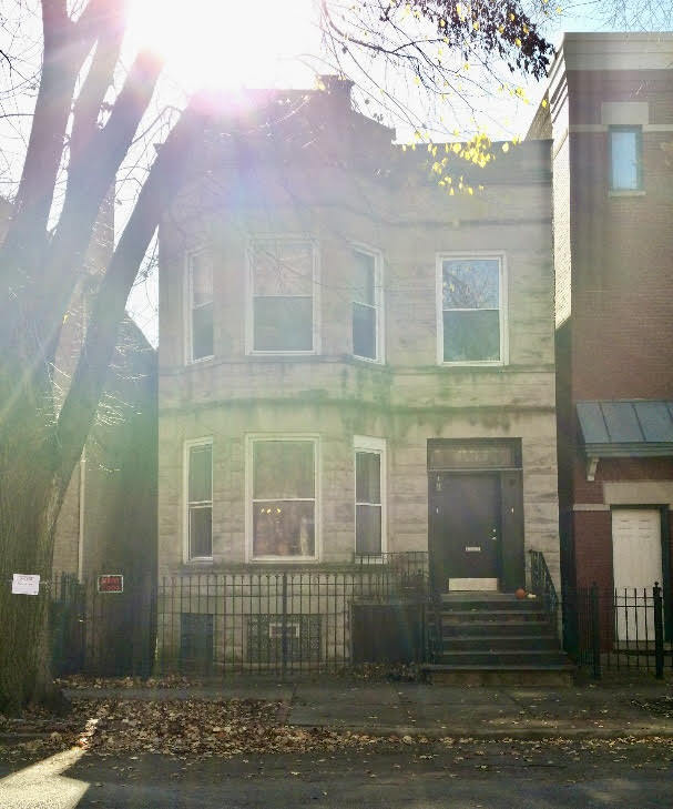 a view of a brick building next to a yard