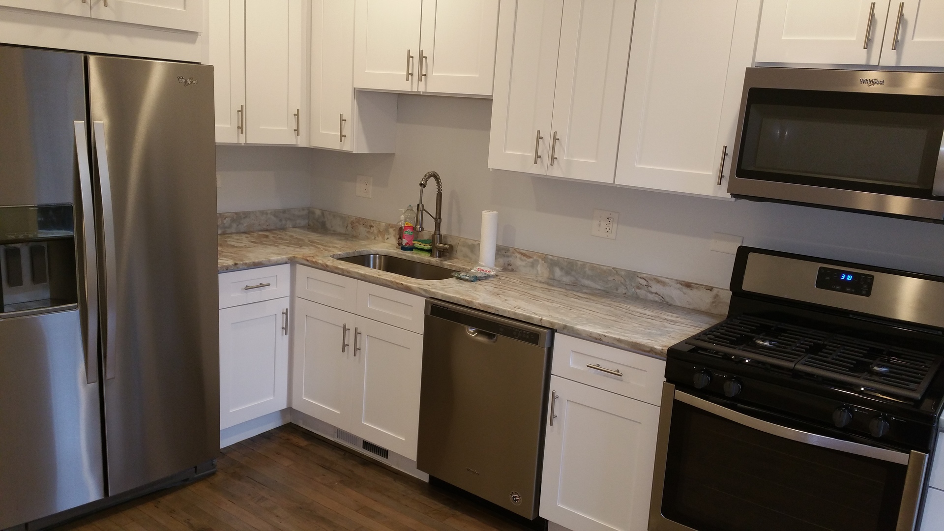 1309 West Fillmore Street, Unit 1 Chicago, IL 60607 - Photo 2 of 9 a kitchen with a sink stove and refrigerator