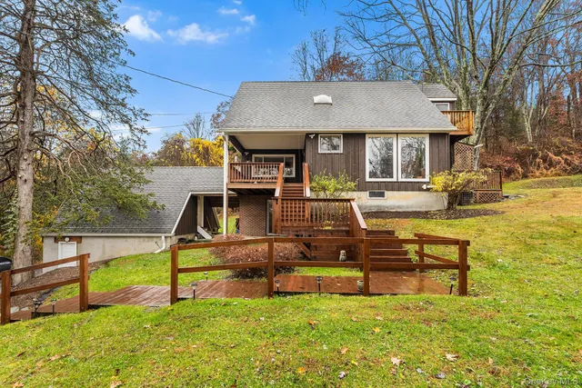 a view of a house with swimming pool and sitting area