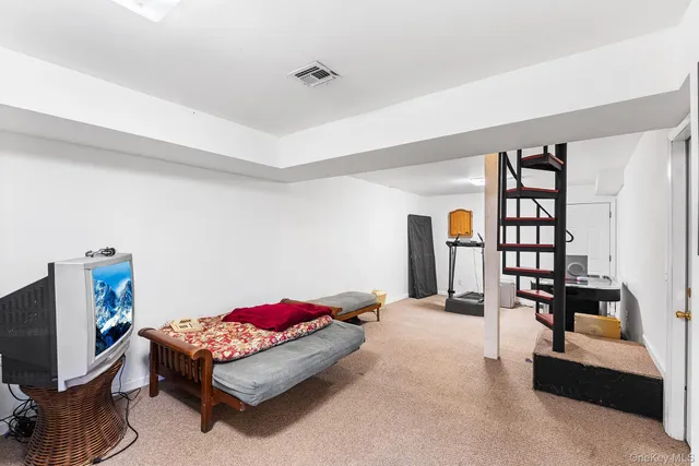 a bedroom with furniture and a flat screen tv