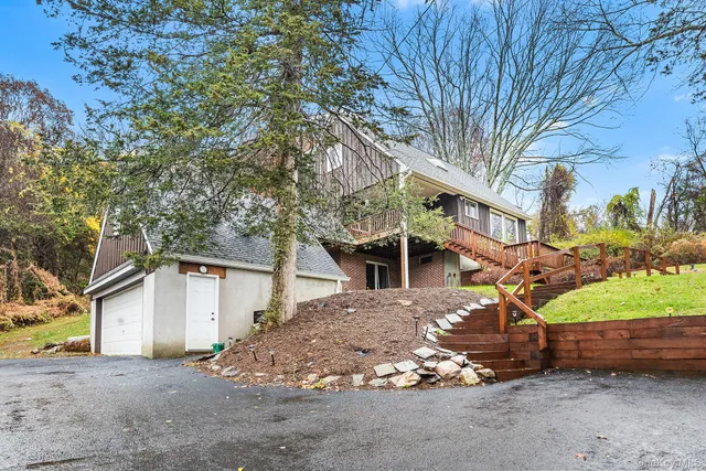 a view of a house with a tree in the background
