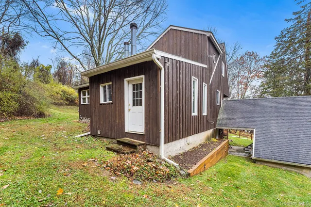 a view of backyard with large trees and a small yard