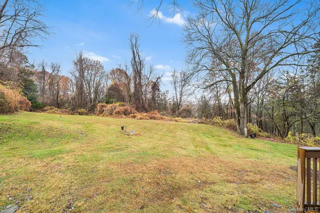 a view of yard with swimming pool and trees