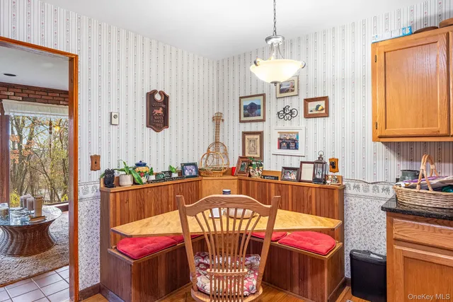 a dining room with furniture a window and wooden floor