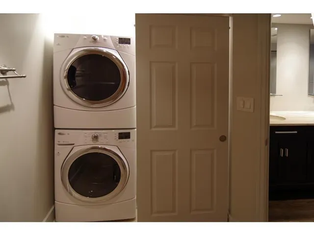 a view of a hallway with washer and dryer